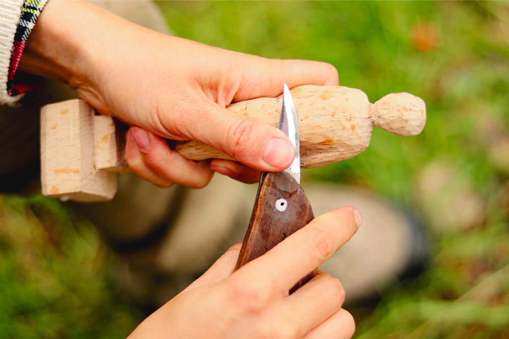 A wood figure being whittled to suggest how a work may look less refined if abridged vs. unabridged