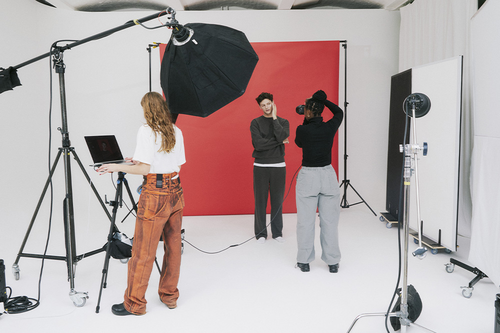 Creative professionals in a studio setting with a subject who looks upset to suggest the waste of going overboard on services unrelated to amazon marketing services