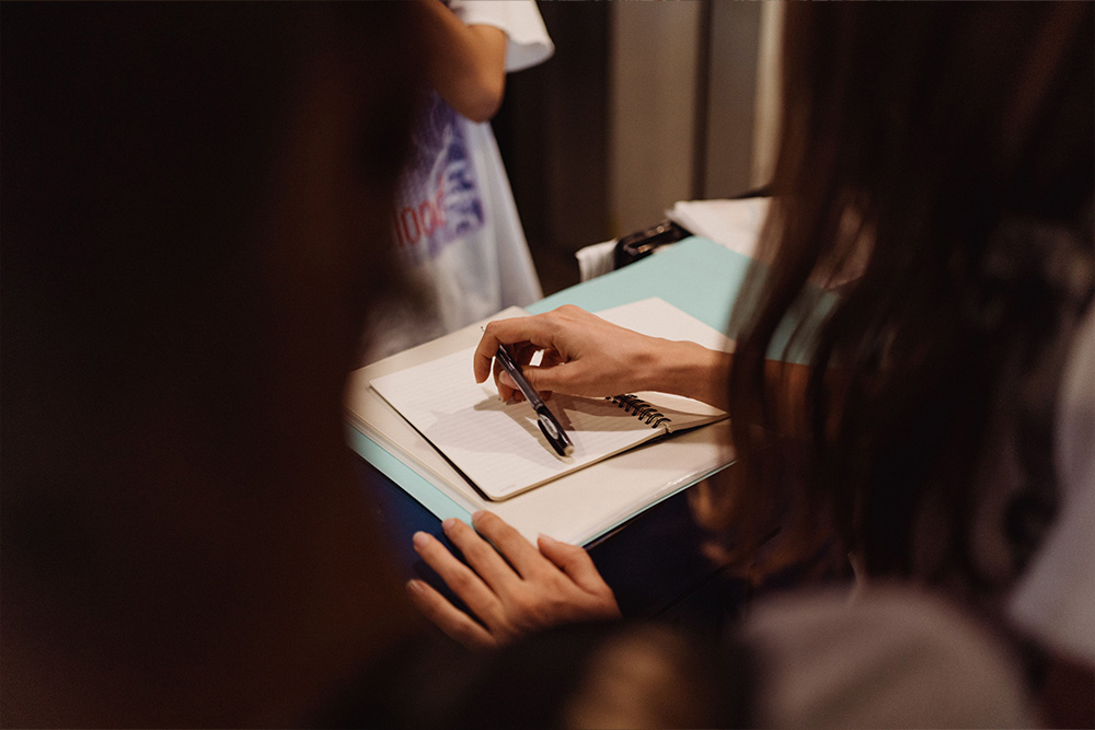 A blank page squeezes into view between one writer and another, mirroring the condition of and lending itself to a visual parallel for when to use contractions in writing