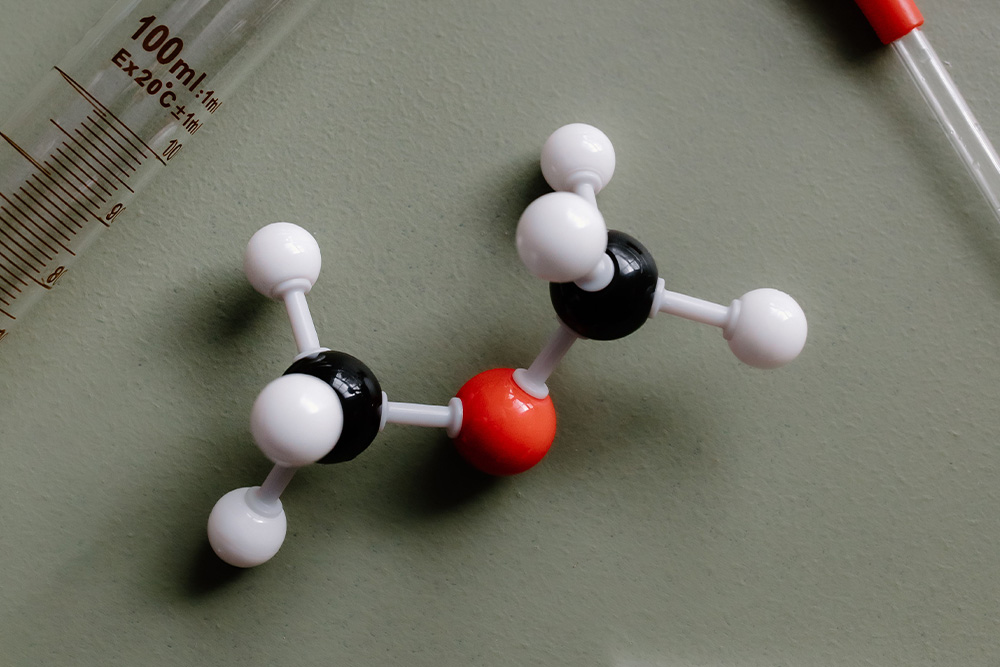 A picture of atom structures and science equipment to symbolize being specific