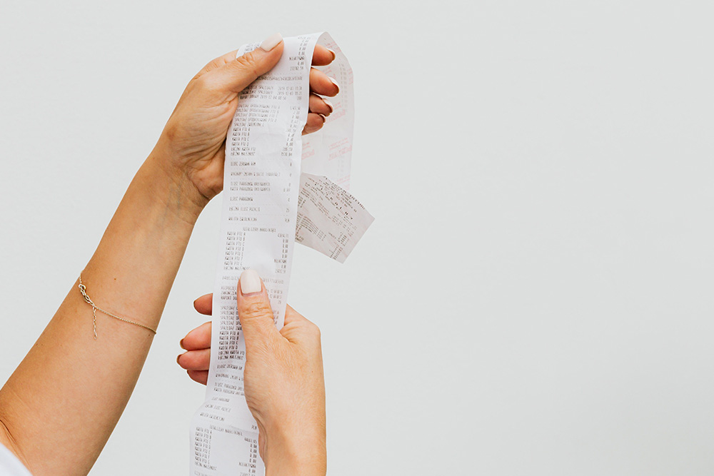 A really long receipt suggests hidden costs in the question how much does it cost to publish a book?
