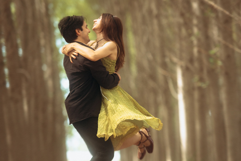 A woman and a man spinning arm in arm to suggest the awareness of readers of romance book tropes