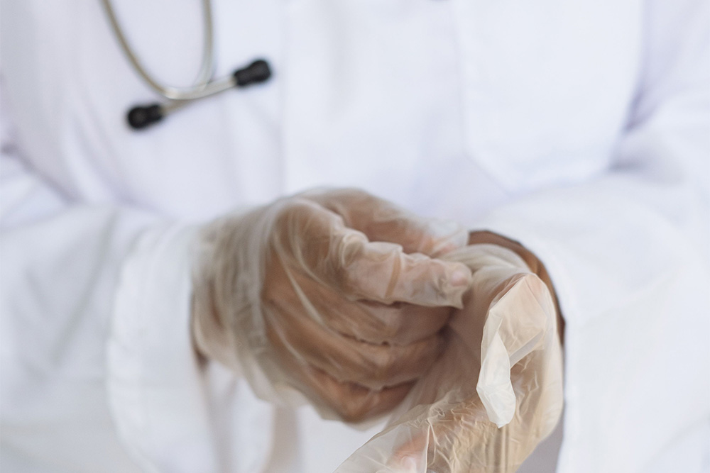 A pair of surgical gloves being taken off as a visual for how to end a memoir as according to Paul kalanithi's novel