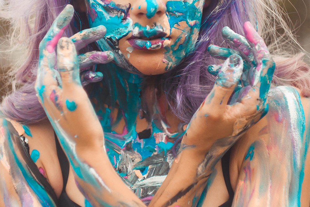 A woman with paint on her and hair color in to suggest transformation in how to end a memoir