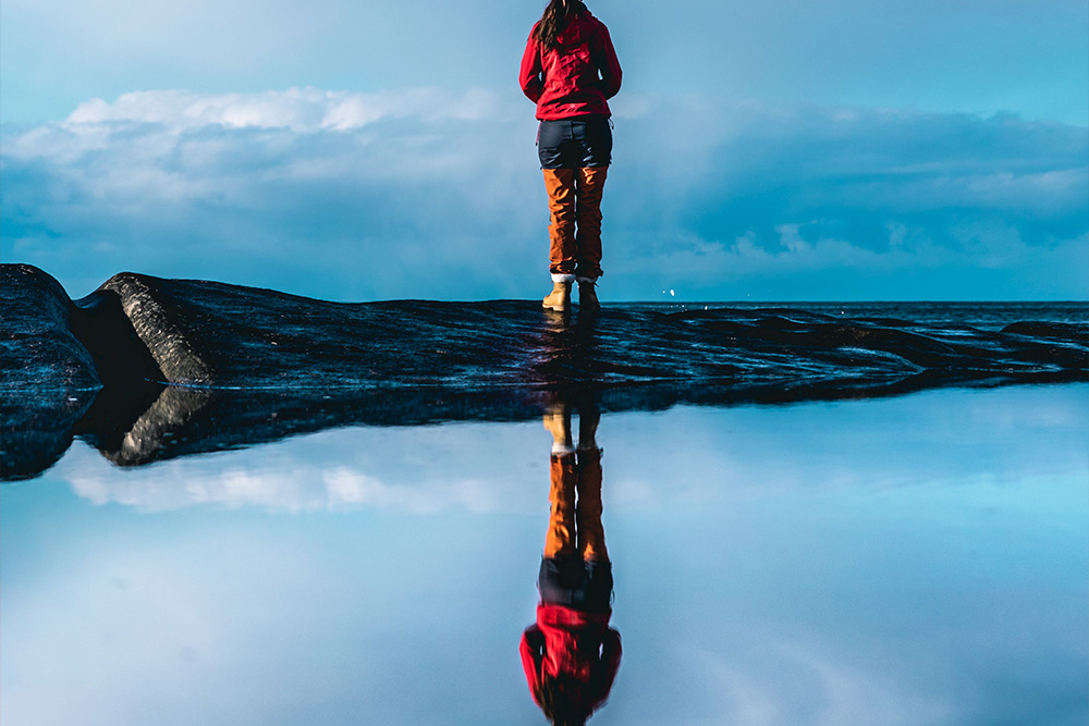 A reflection in a mountaintop pool suggests that tone is reflected in the subject against the atmosphere
