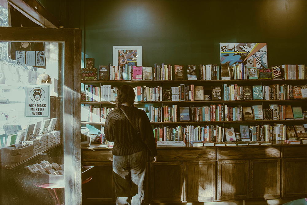A person staring at a big volume of books suggests that it is important to know what is an imprint