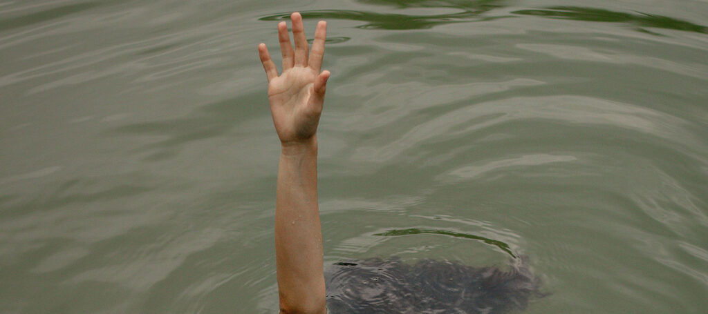 A woman trying to emerge from water as a visual parallel for theme in elements of fiction