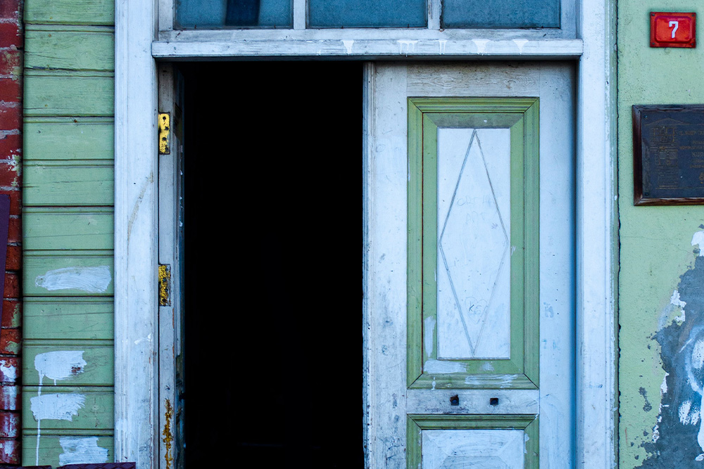 Image of a door with the number 7 next to an opened door to suggest elements of fiction with a sense of mystery and invitation
