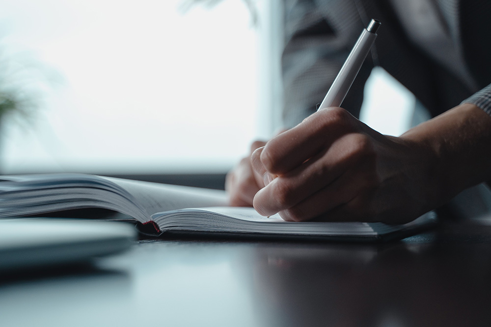 A page being written in a sleek and clean environment to suggest the importance of what to know before submit