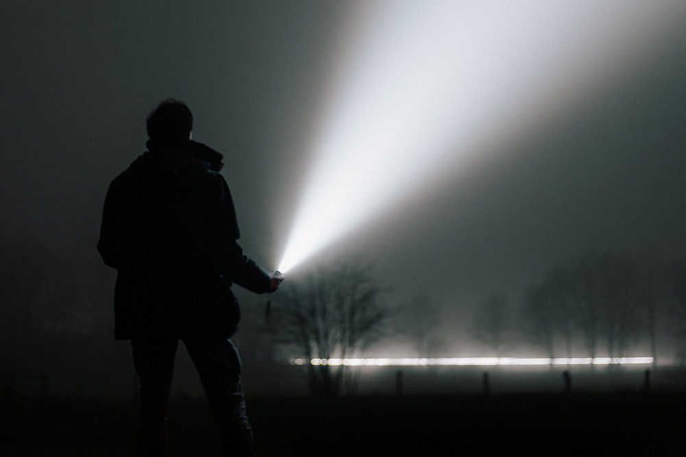 Shining a flashlight into darkness is the process of going into the dilemma of a story to find a dramatic question
