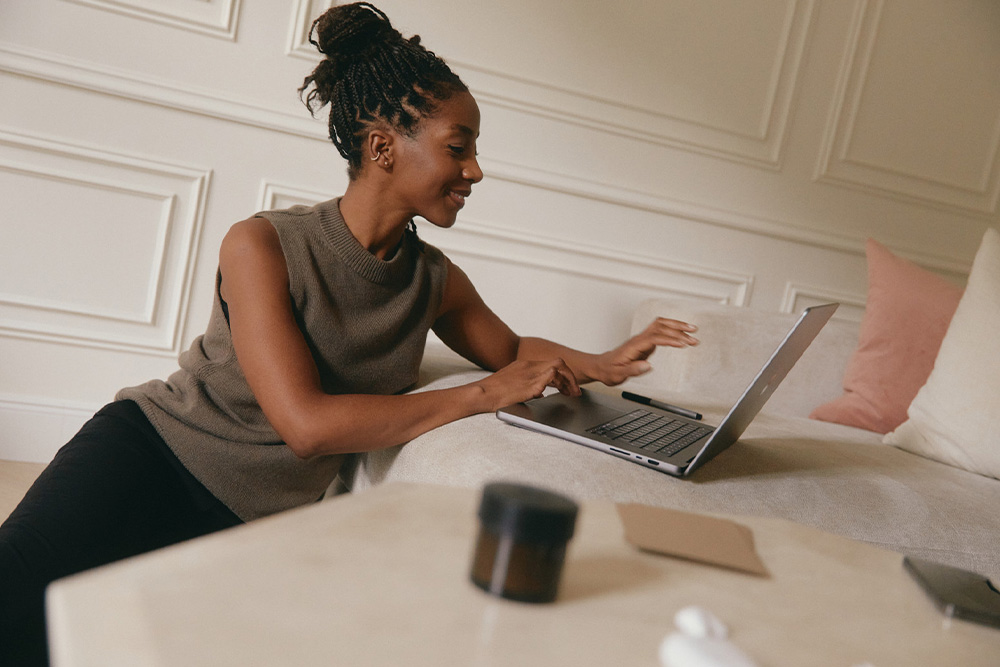 Someone at a computer who looks very happy, how to be happy how to get a book deal