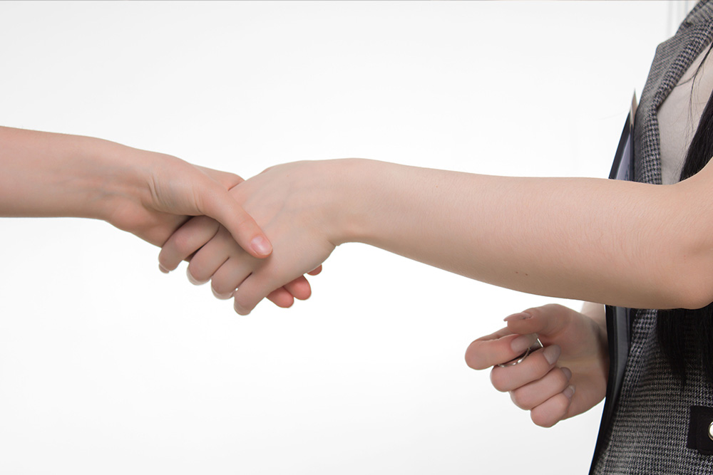 A handshake in a professional environment to visualize selecting a good hybrid publishing