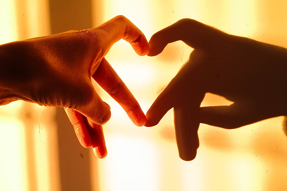 Love expressed in a small hand gesture to show how literary fiction differentiates its depictions of love