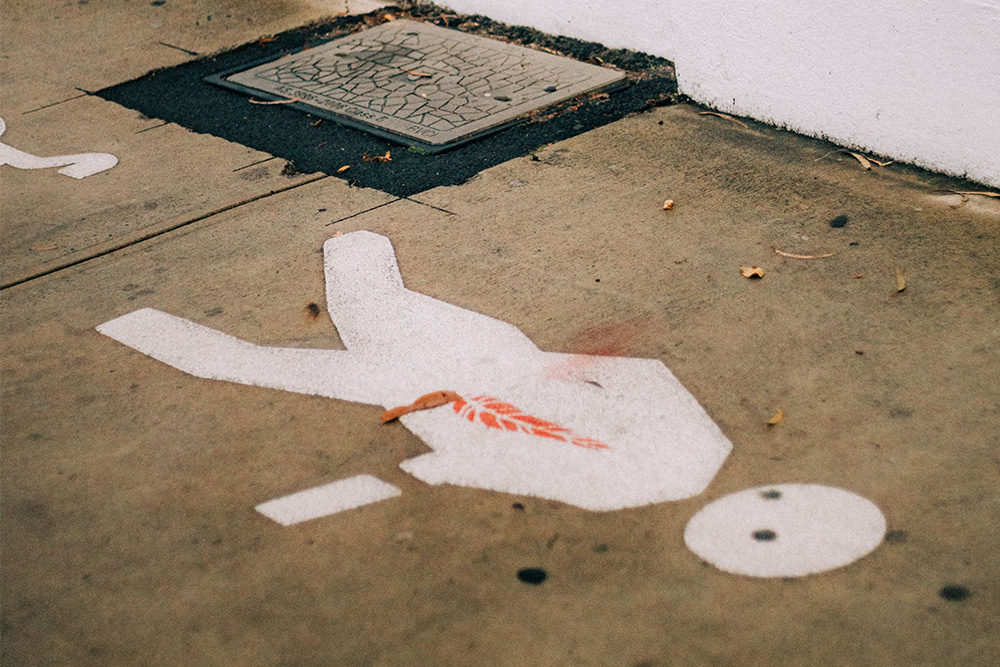 A chalk painted outline on the ground to suggest reverse outlining