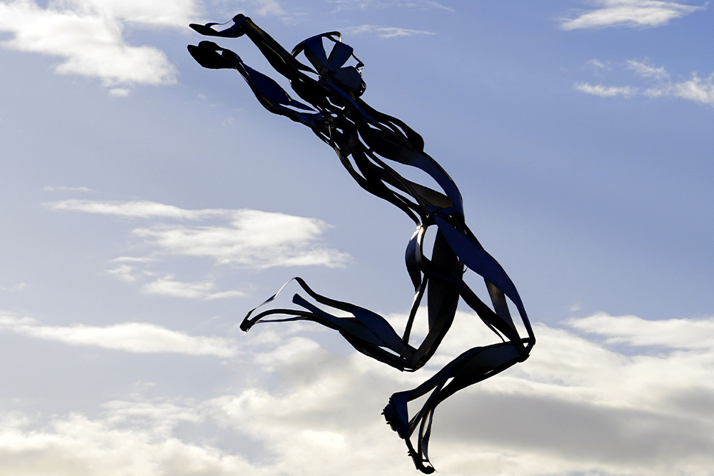 A statue jumping through the air to abstract the freedom of the seeker archetype