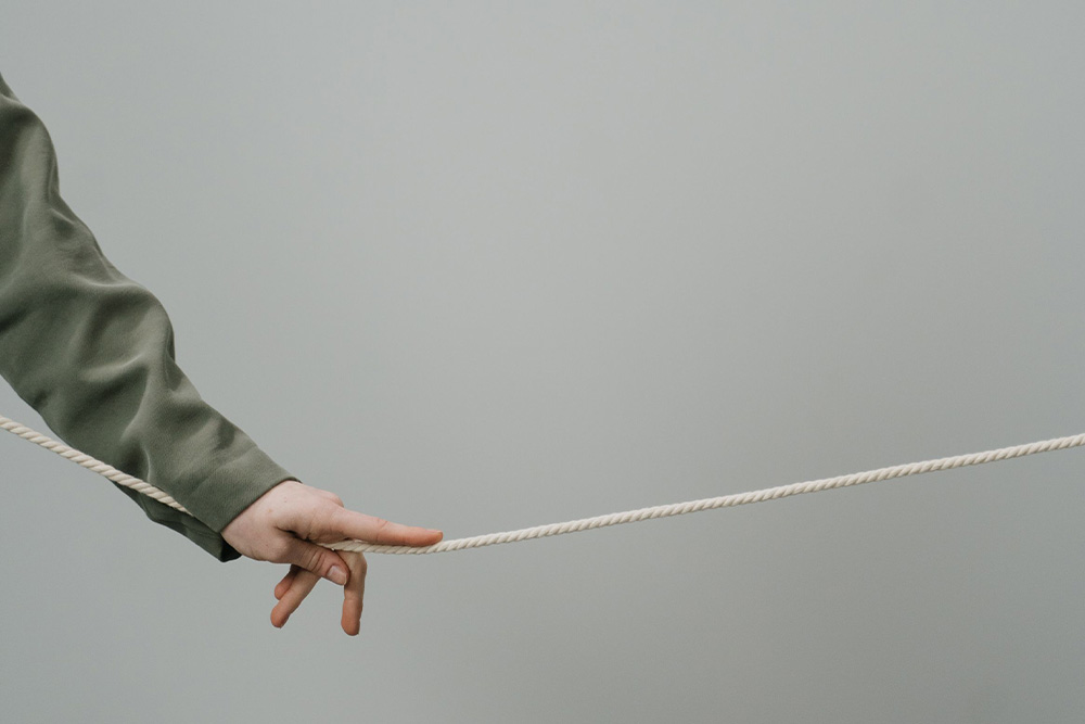 A hand running over rope to suggest suspense