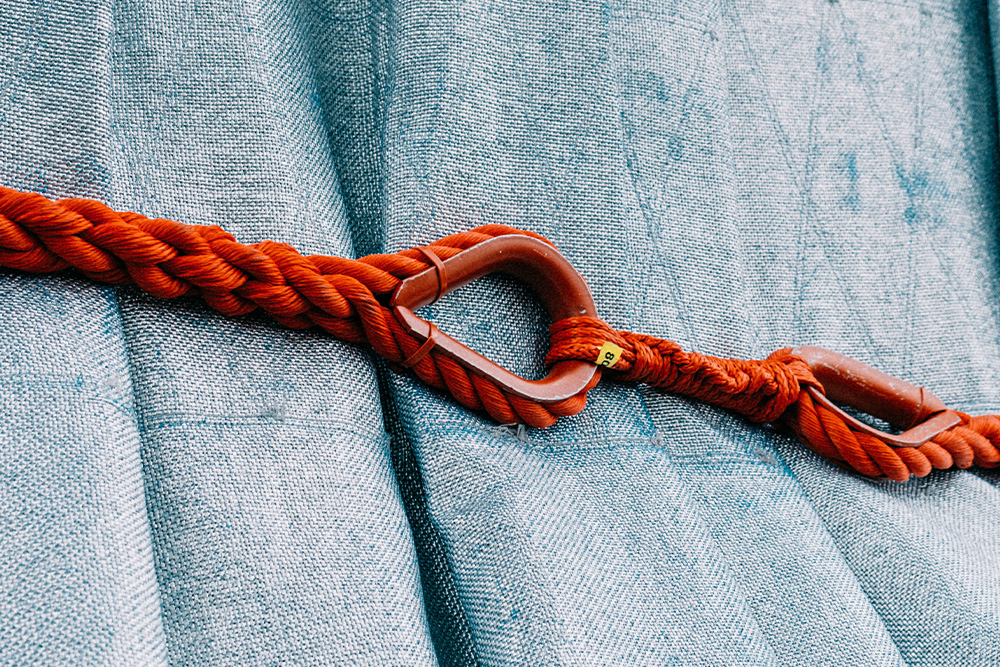 A knot around a big piece of padding to suggest how suspense compresses a story effectively