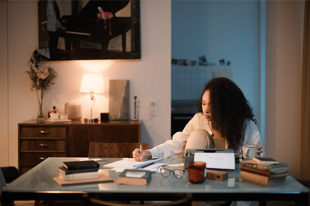 Someone working hard at a desk to suggest how to write suspense