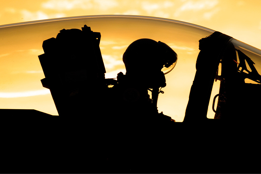 A fighter pilot in silhouette suggests that the right theme ideas makes the person irrelevant and the character that they are based on more important in service of the artistic work