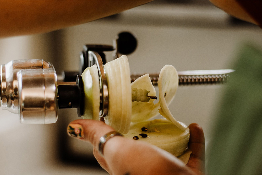 An apple core being dismantled by a machine crank to suggest that theme ideas can be gotten to mechanistically with our blog