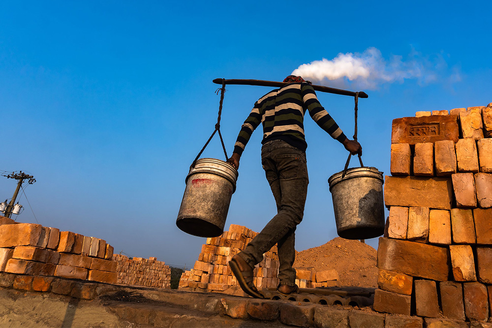 A man carrying water from the well suggest how vivid verbs bring life into the work