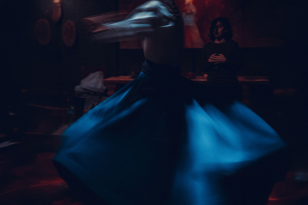 Someone dancing in motion with a still subject in the background to suggest the role vivid verbs take with relation to a reader