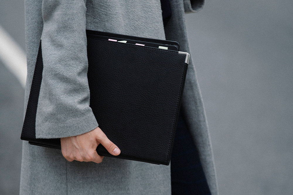 A writing portfolio held in someone's hand