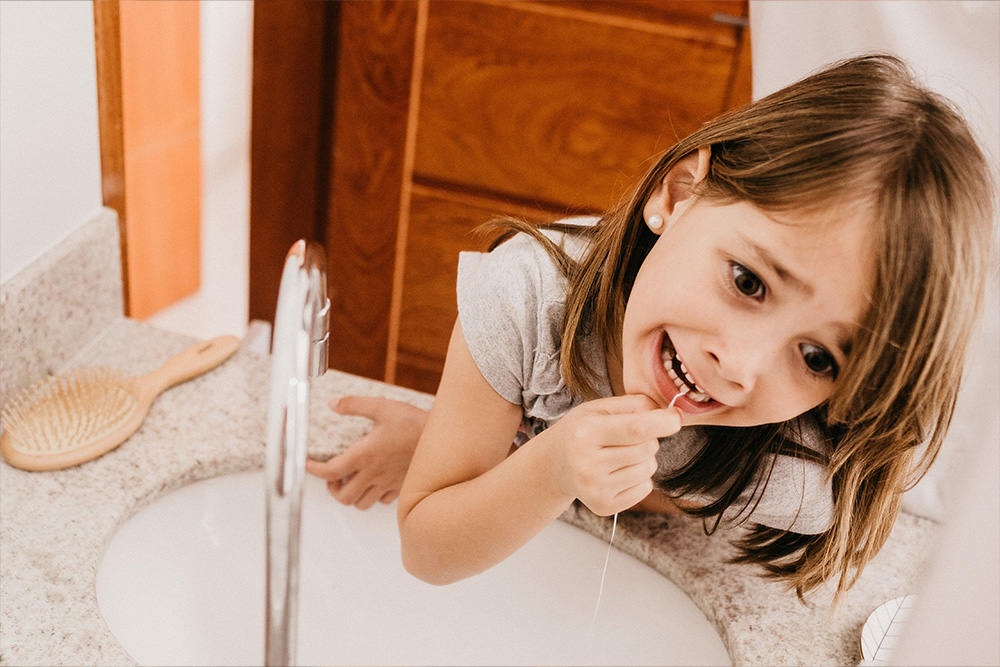 Flossing teeth as a visual parallel for an important habit of a kindlepreneur