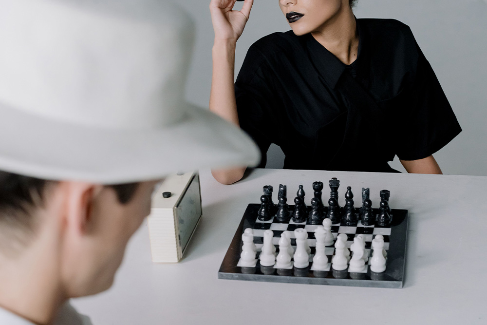 Two people playing chess to suggest personality strengths and weaknesses