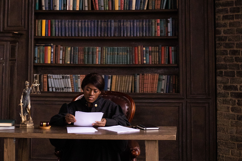 A judge set against a background of many law books to suggest how writers may write off young adult fiction easily