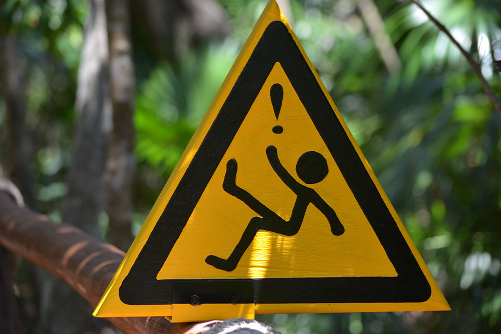 A hazard sign for tripping to warn writers to avoid these mistakes in a character bio template