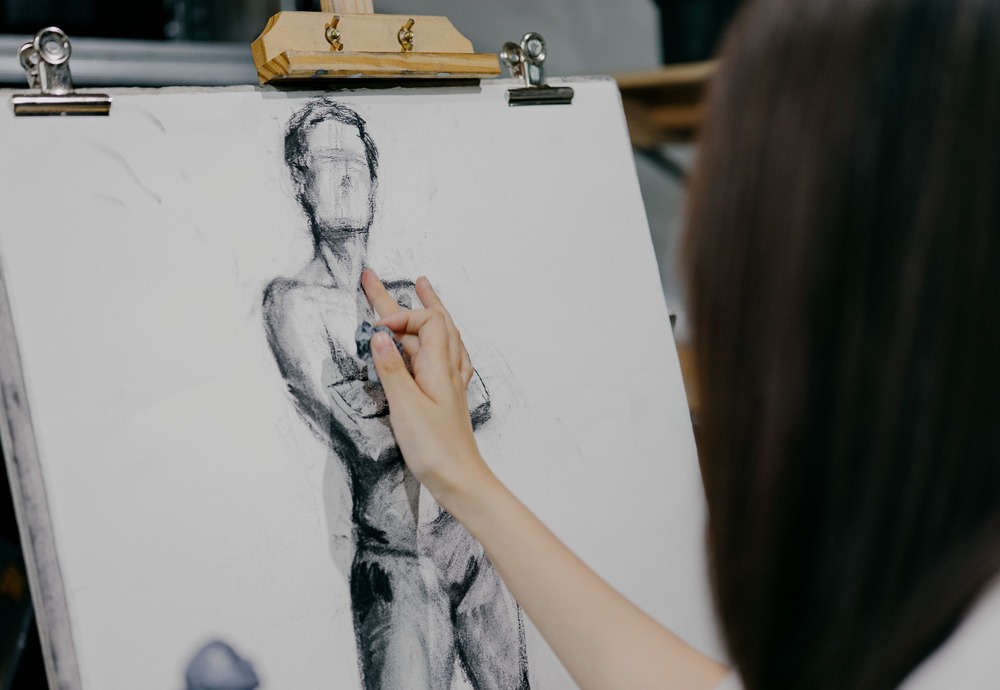 A creative writer taking time to sketch out their protagonist, who they know more about thanks to the character bio template.